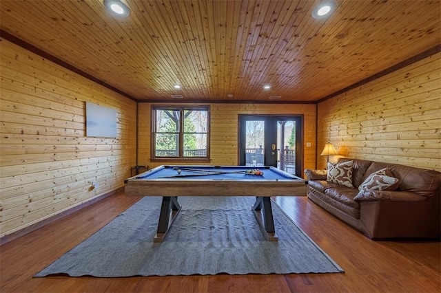 rec room with billiards, wood-type flooring, wooden ceiling, french doors, and wood walls