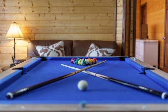 rec room with pool table and wooden walls