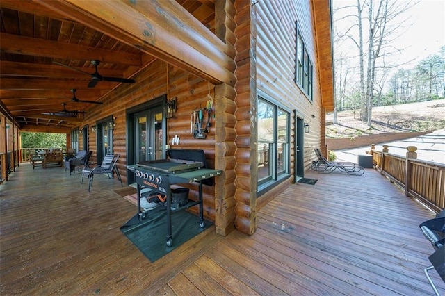 wooden deck featuring ceiling fan and french doors