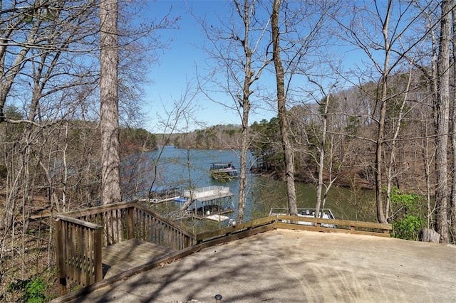 wooden terrace with a water view and a boat dock