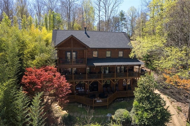 back of house featuring a wooden deck, a balcony, and french doors