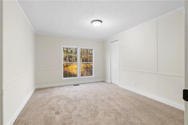 32 Brent Cir SW, Cartersville, GA 30120 - empty room with baseboards, visible vents, ornamental molding, a textured ceiling, and carpet flooring