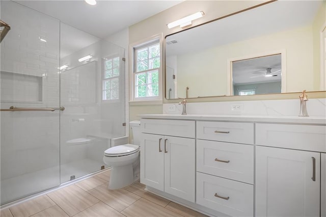 3320 Woodleaf Way, Marietta, GA 30062 - full bathroom featuring toilet, a shower stall, double vanity, and a ceiling fan