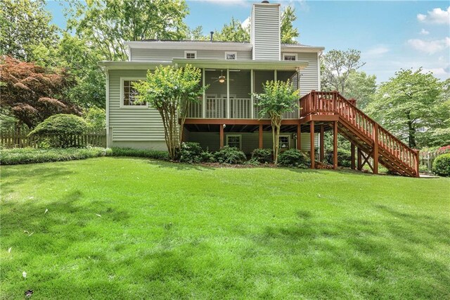 3320 Woodleaf Way, Marietta, GA 30062 - rear view of house with stairway, a sunroom, a chimney, and a yard