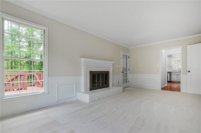3320 Woodleaf Way, Marietta, GA 30062 - unfurnished living room with carpet, crown molding, a wainscoted wall, a brick fireplace, and a decorative wall