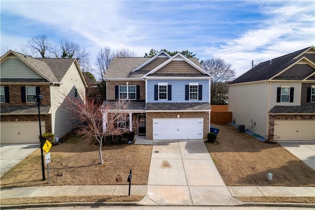 craftsman house with a garage, concrete driveway, and brick siding