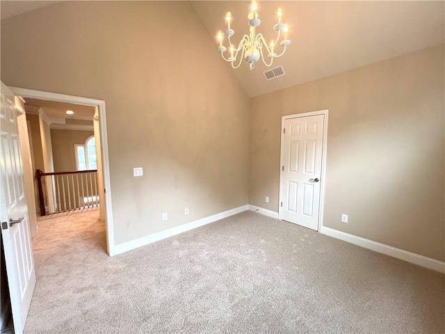 spare room featuring light carpet, ceiling fan, crown molding, and a tray ceiling