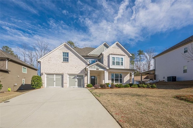 craftsman house with a garage, central AC unit, and a front lawn