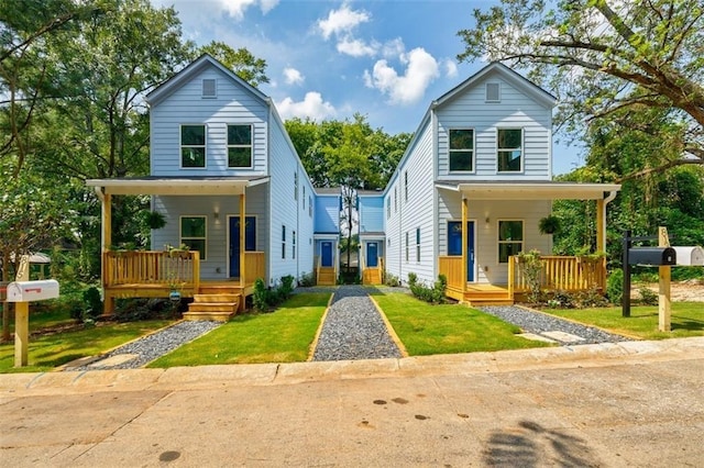 view of front facade with a front yard and covered porch