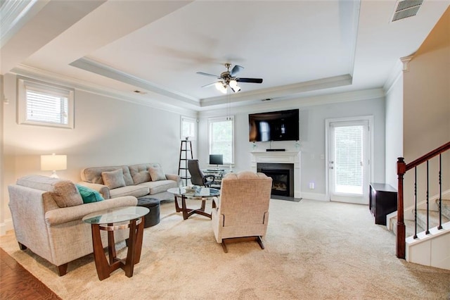 555 Lance View Ln, Lawrenceville, GA 30045 - living area with a tray ceiling, plenty of natural light, ornamental molding, a fireplace with flush hearth, and stairway