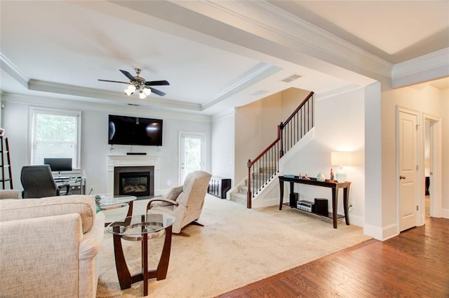 555 Lance View Ln, Lawrenceville, GA 30045 - living room featuring stairway, healthy amount of natural light, wood finished floors, a ceiling fan, and crown molding