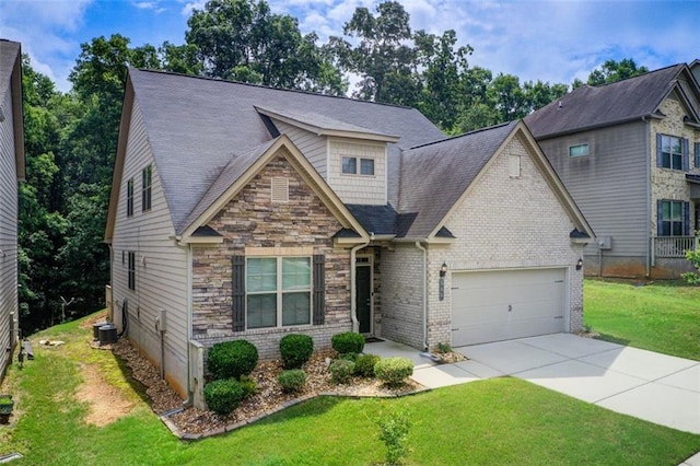 555 Lance View Ln, Lawrenceville, GA 30045 - craftsman-style house with a garage, driveway, a front lawn, stone siding, and central air condition unit