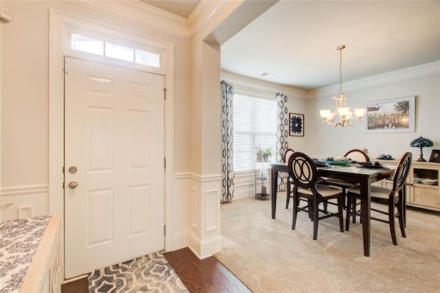 555 Lance View Ln, Lawrenceville, GA 30045 - entryway with a chandelier, plenty of natural light, ornamental molding, a wainscoted wall, and wood finished floors