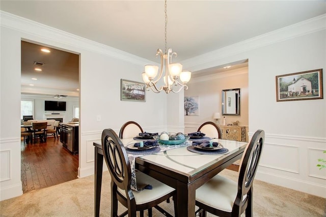 555 Lance View Ln, Lawrenceville, GA 30045 - dining room featuring a decorative wall, crown molding, light carpet, a chandelier, and a wainscoted wall