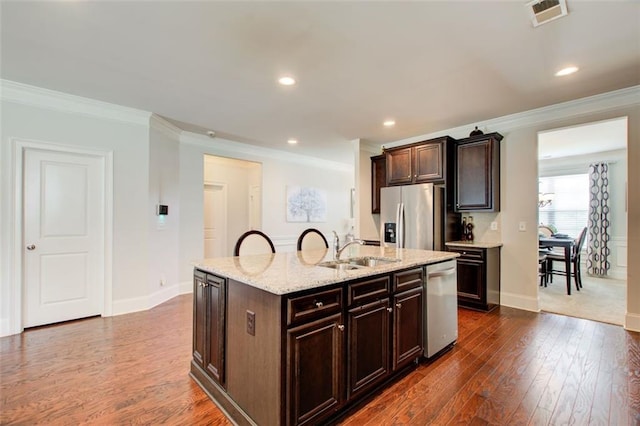 555 Lance View Ln, Lawrenceville, GA 30045 - kitchen featuring appliances with stainless steel finishes, a sink, ornamental molding, dark wood-style floors, and baseboards