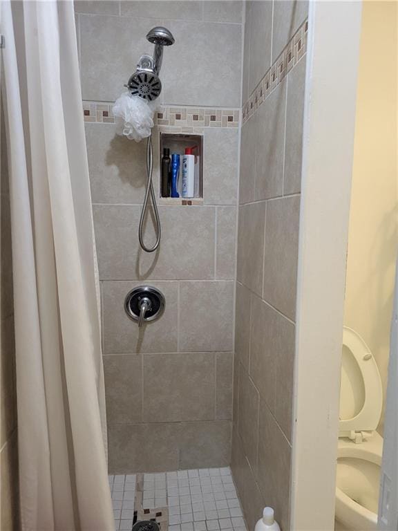 bathroom with tiled shower
