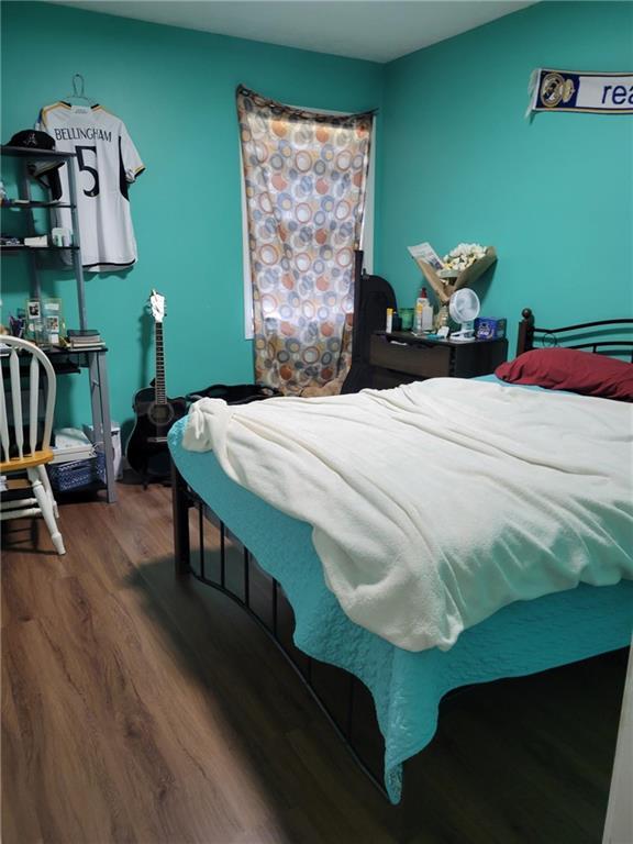 bedroom with wood finished floors