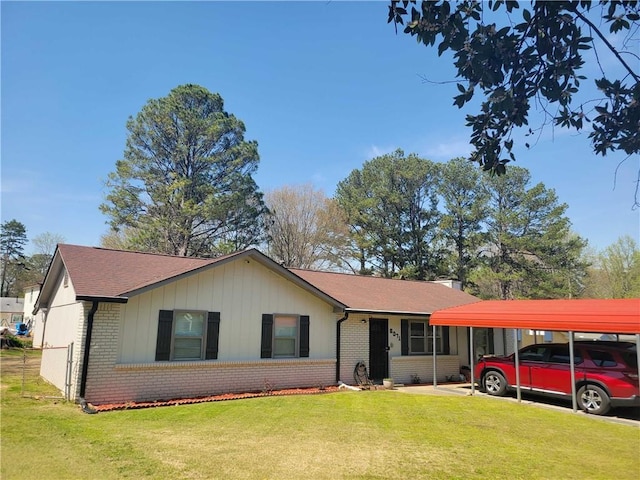 ranch-style house featuring a front lawn, a shingled roof, brick siding, and a carport