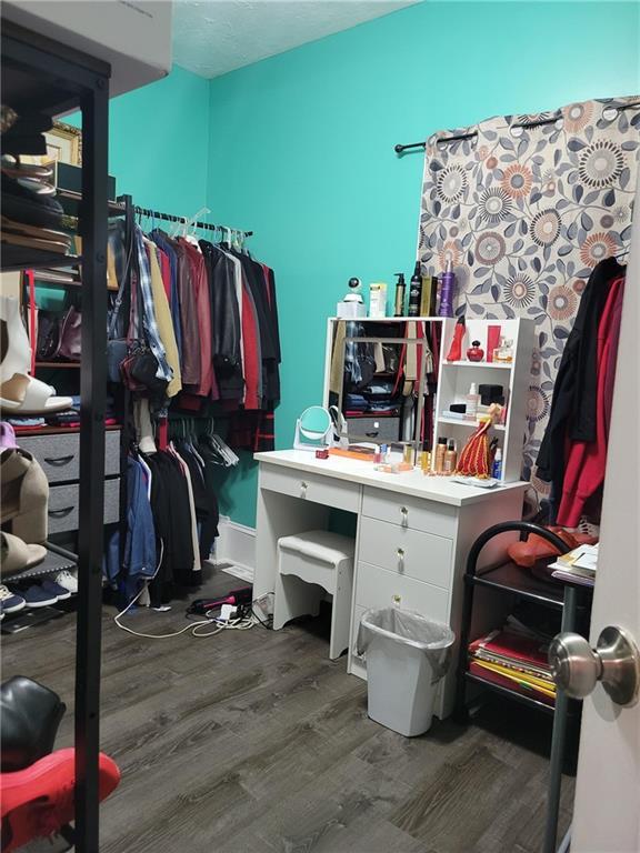 spacious closet with wood finished floors