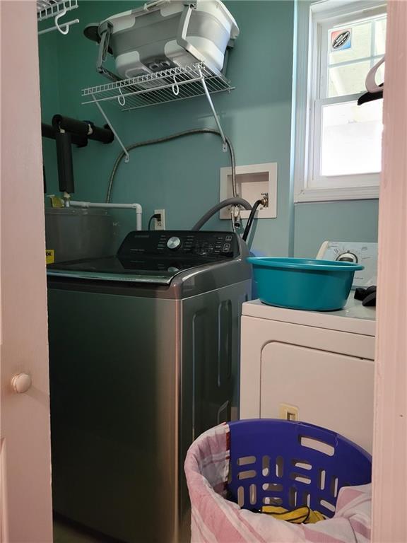 clothes washing area with washing machine and dryer and laundry area