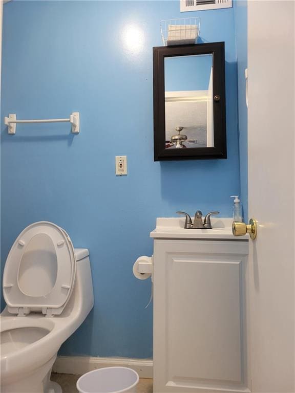 half bath featuring toilet, visible vents, and vanity