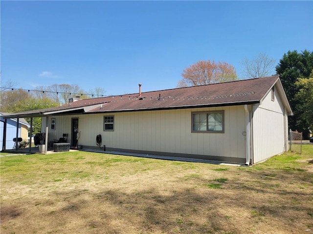 back of property with a lawn and central air condition unit