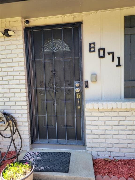 property entrance with brick siding