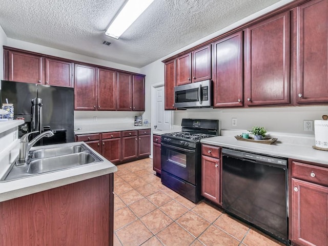 20 Preserve Dr, Newnan, GA 30263 - kitchen with black appliances, reddish brown cabinets, light tile patterned flooring, light countertops, and a textured ceiling
