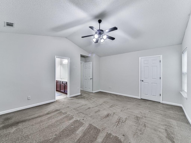 20 Preserve Dr, Newnan, GA 30263 - unfurnished bedroom featuring a textured ceiling, lofted ceiling, carpet flooring, ensuite bathroom, and a ceiling fan