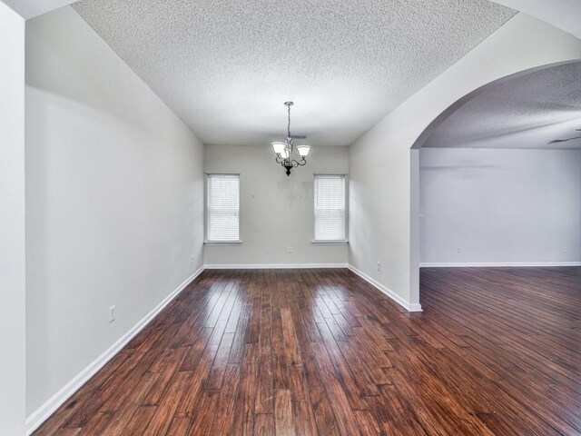 20 Preserve Dr, Newnan, GA 30263 - empty room with a textured ceiling, a chandelier, arched walkways, and wood finished floors