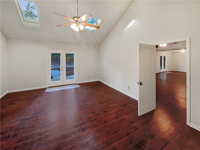 spare room with ceiling fan, french doors, dark wood-type flooring, high vaulted ceiling, and a skylight