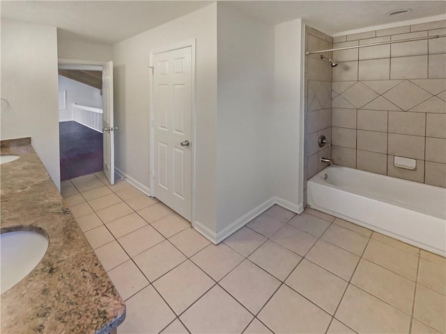 bathroom featuring vanity, tiled shower / bath, and tile patterned flooring