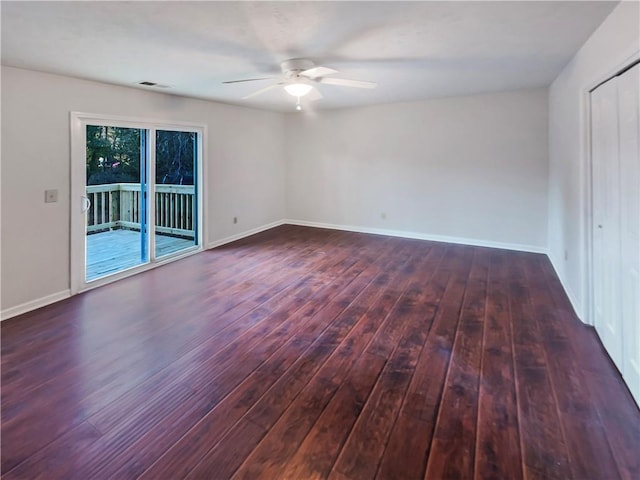 spare room featuring ceiling fan and dark hardwood / wood-style floors