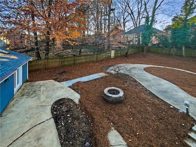 view of yard with a fire pit and a patio