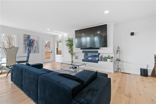 living room featuring light hardwood / wood-style floors and a wealth of natural light