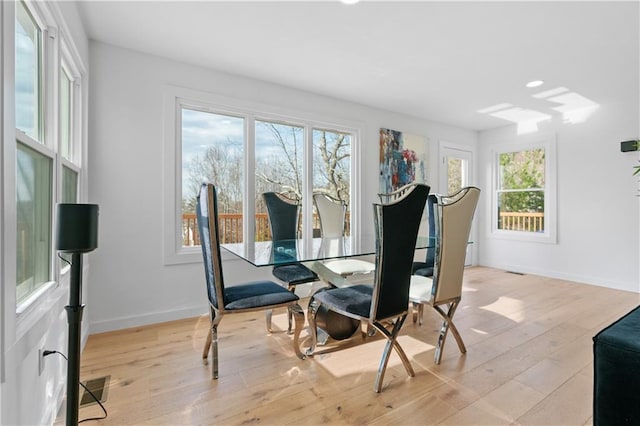 dining space featuring light wood-type flooring