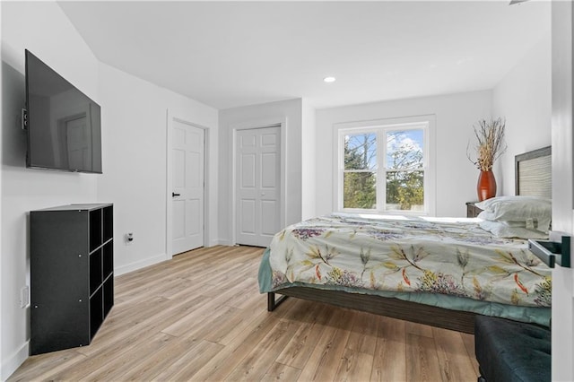 bedroom featuring light wood-type flooring and a closet