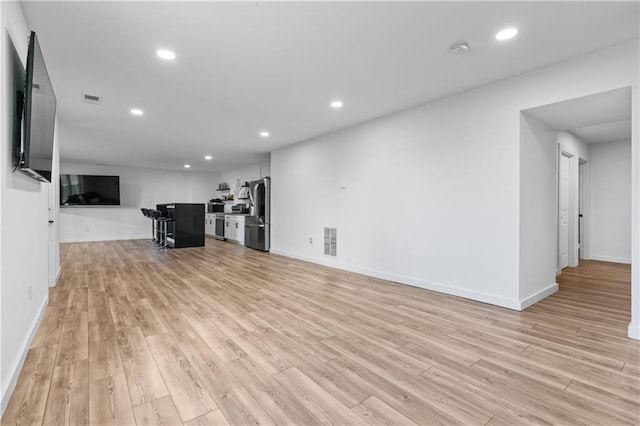 unfurnished living room with light hardwood / wood-style flooring