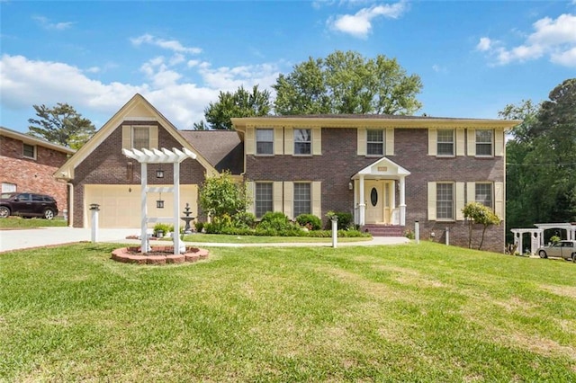 colonial inspired home with brick siding, a garage, a front lawn, and concrete driveway