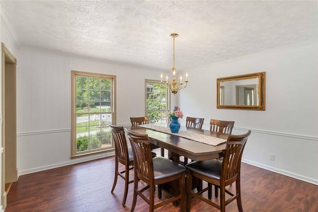 dining area with a textured ceiling, crown molding, baseboards, a chandelier, and dark wood-type flooring