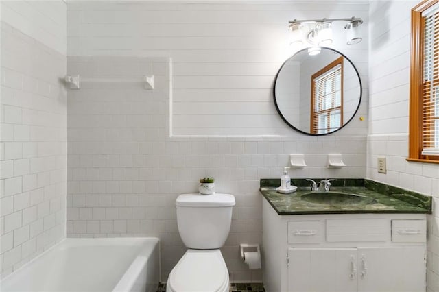 bathroom with toilet, tile walls, and vanity