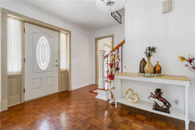 foyer with crown molding, baseboards, a chandelier, and stairway
