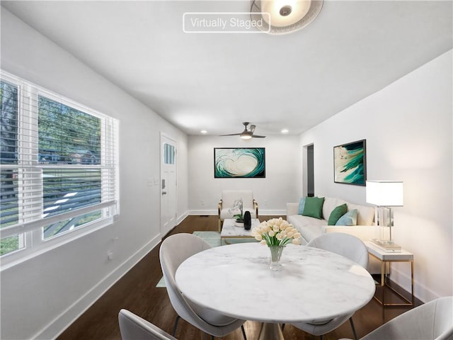 dining space featuring dark wood-type flooring and ceiling fan