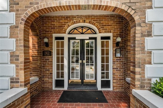 242 12th St NE Unit 1A, Atlanta, GA 30309 - doorway to property featuring french doors and brick siding