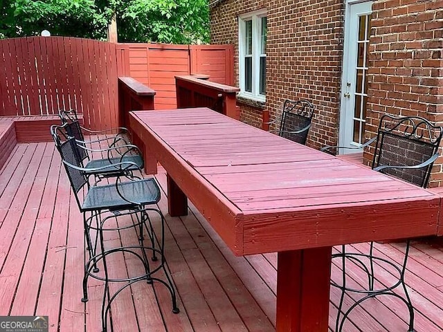 wooden terrace featuring outdoor dining space