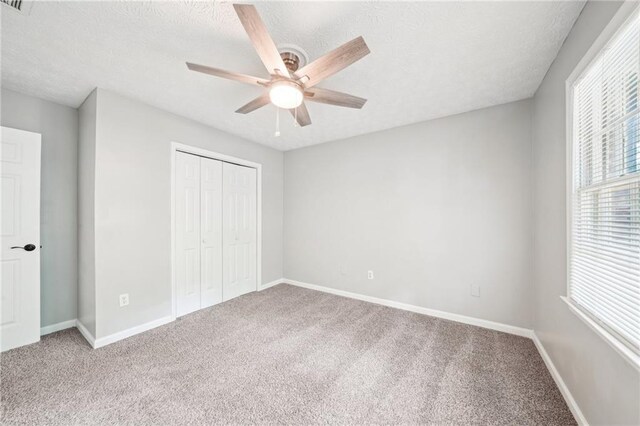 5141 Rocky Run, Stone Mountain, GA 30088 - unfurnished bedroom with carpet floors, a closet, a textured ceiling, baseboards, and ceiling fan
