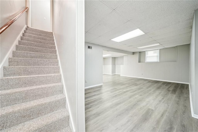 5141 Rocky Run, Stone Mountain, GA 30088 - basement featuring wood finished floors, stairs, a paneled ceiling, and baseboards