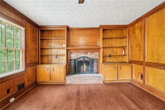 5141 Rocky Run, Stone Mountain, GA 30088 - unfurnished living room with dark wood-type flooring, built in features, a fireplace, ornamental molding, and wooden walls
