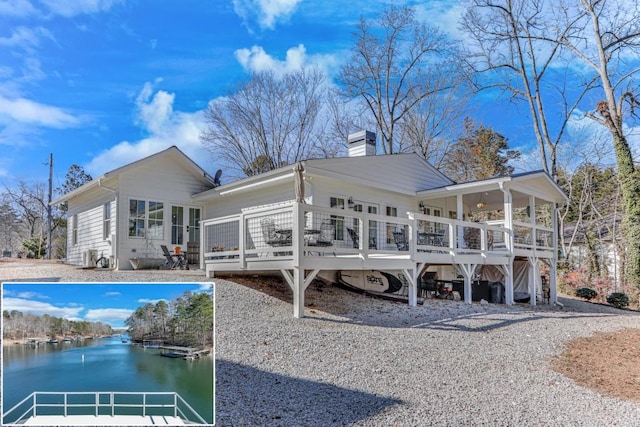 rear view of house with a deck with water view