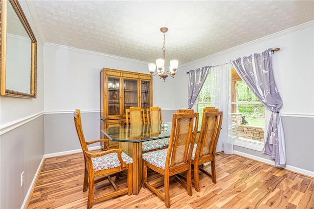 130 Brooklet Way, Brooks, GA 30205 - dining space with a chandelier, a textured ceiling, light wood finished floors, and crown molding